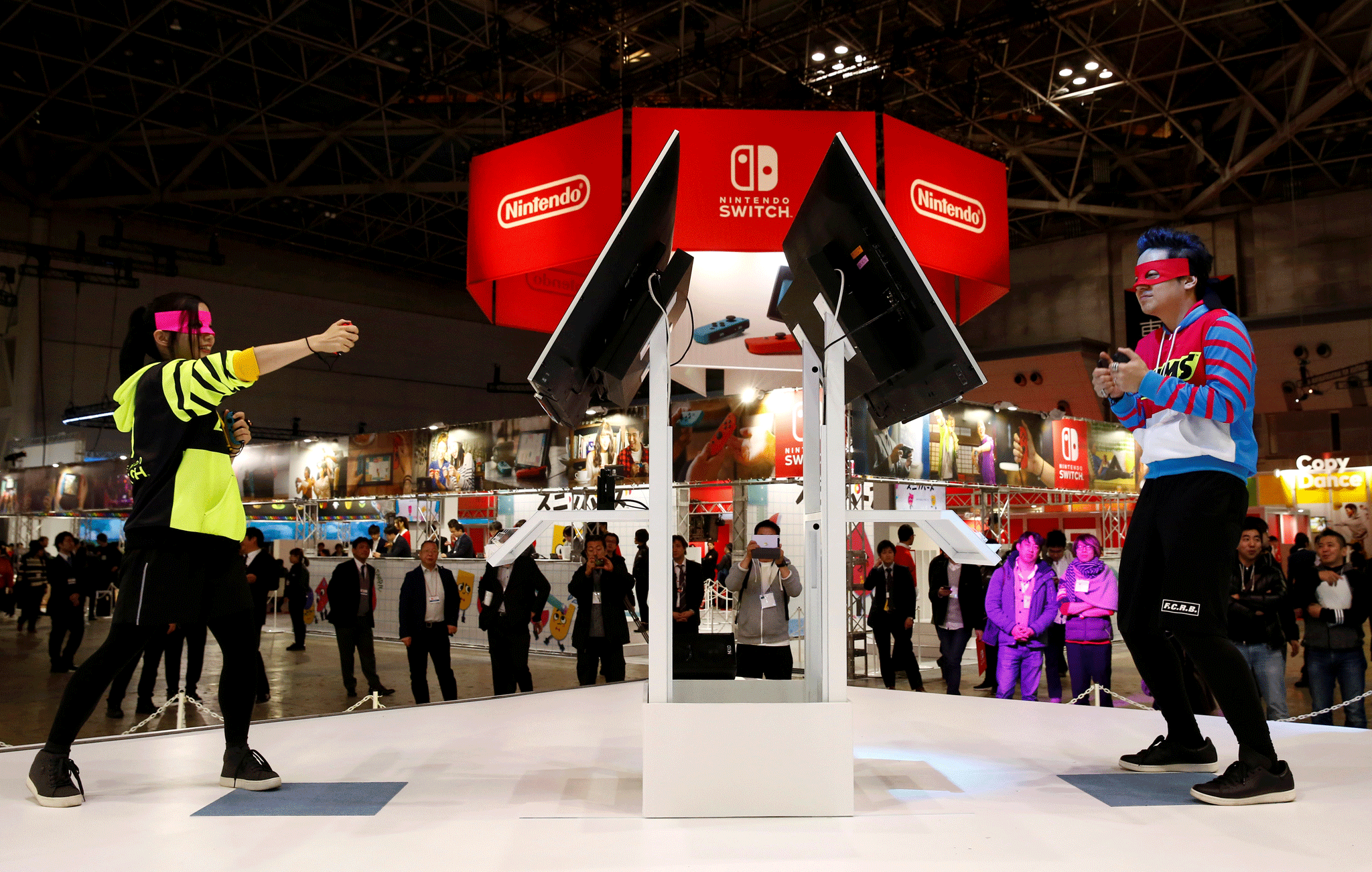 Demonstrators play Nintendo's Arms game with its new game console Switch at its experience venue in Tokyo