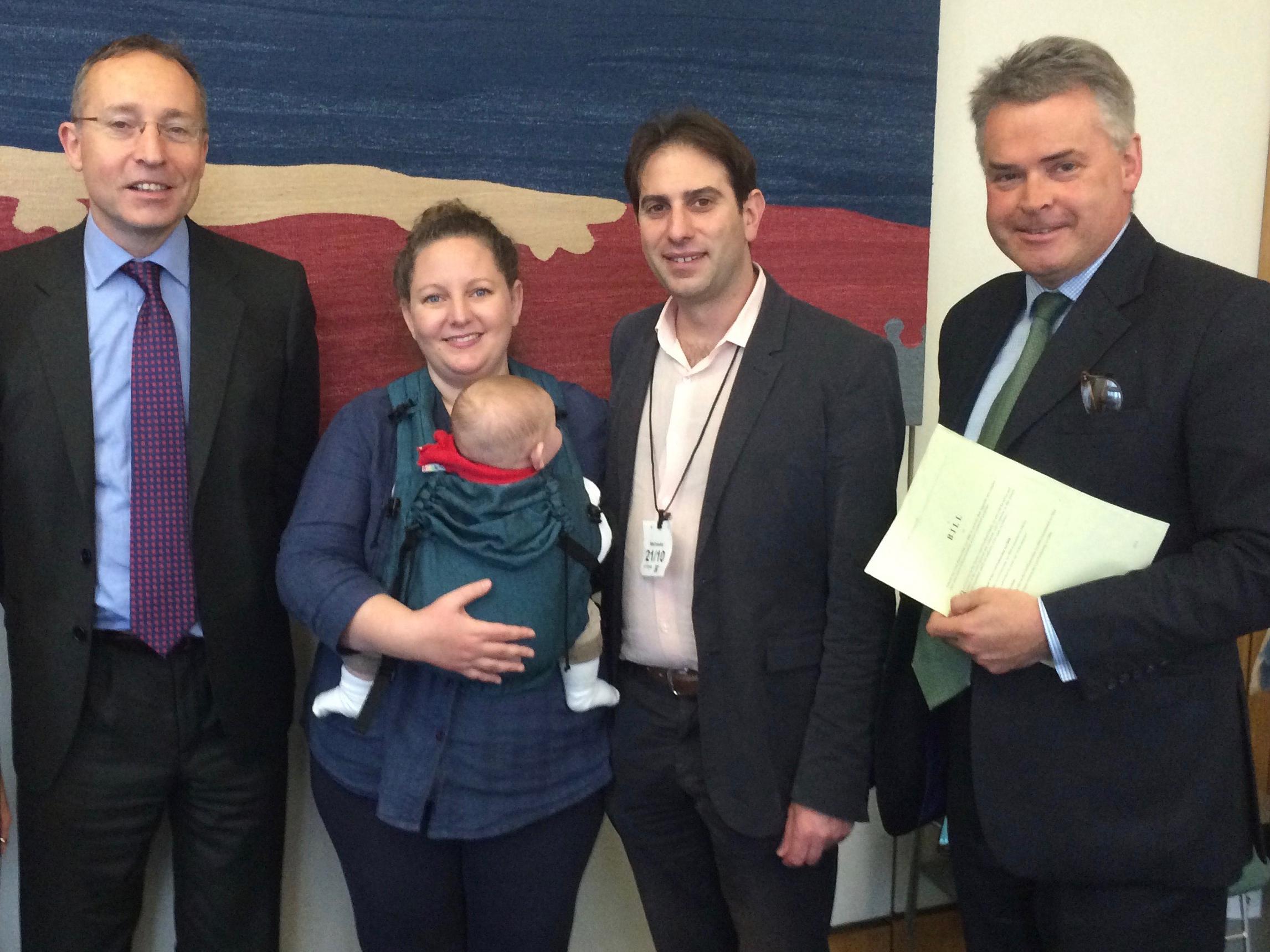 Rebecca Steinfeld and Charles Keiden with their baby and MP Andy Slaughter (left) and Tim Loughton MP (right)