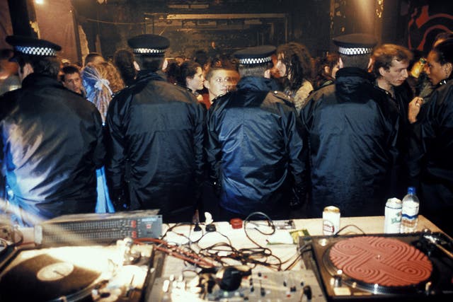 Police stand guard over the decks after busting an illegal warehouse party