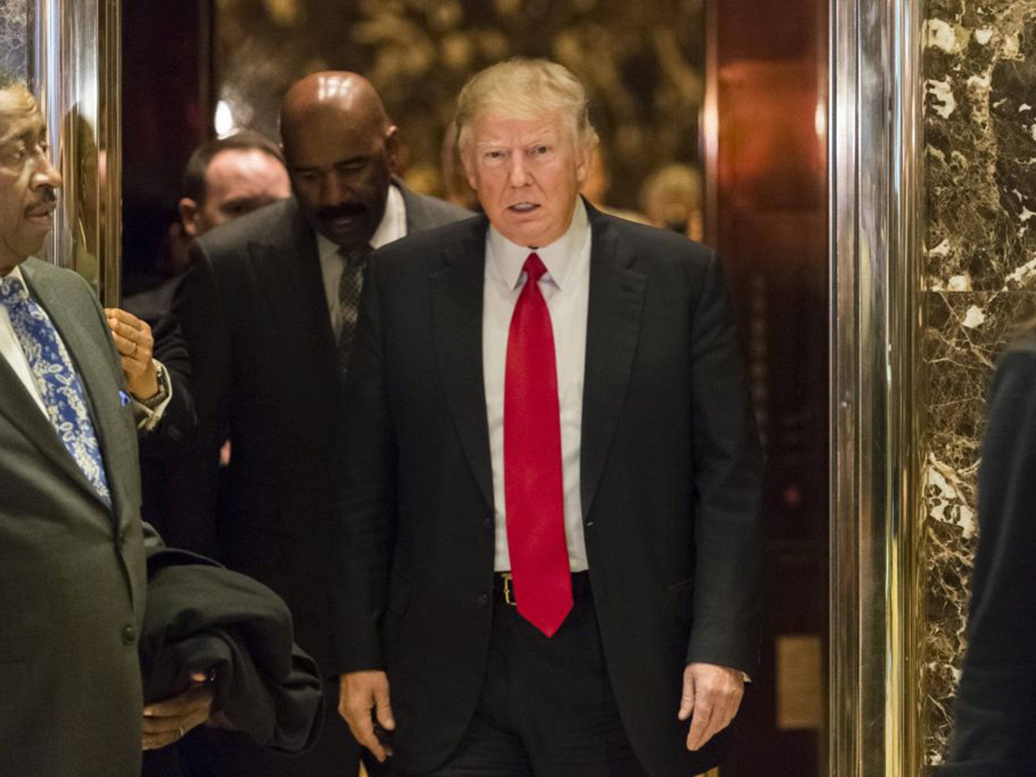 Donald Trump is seen exiting a Trump Tower lift after meeting with US television host Steve Harvey on 13 January 2017