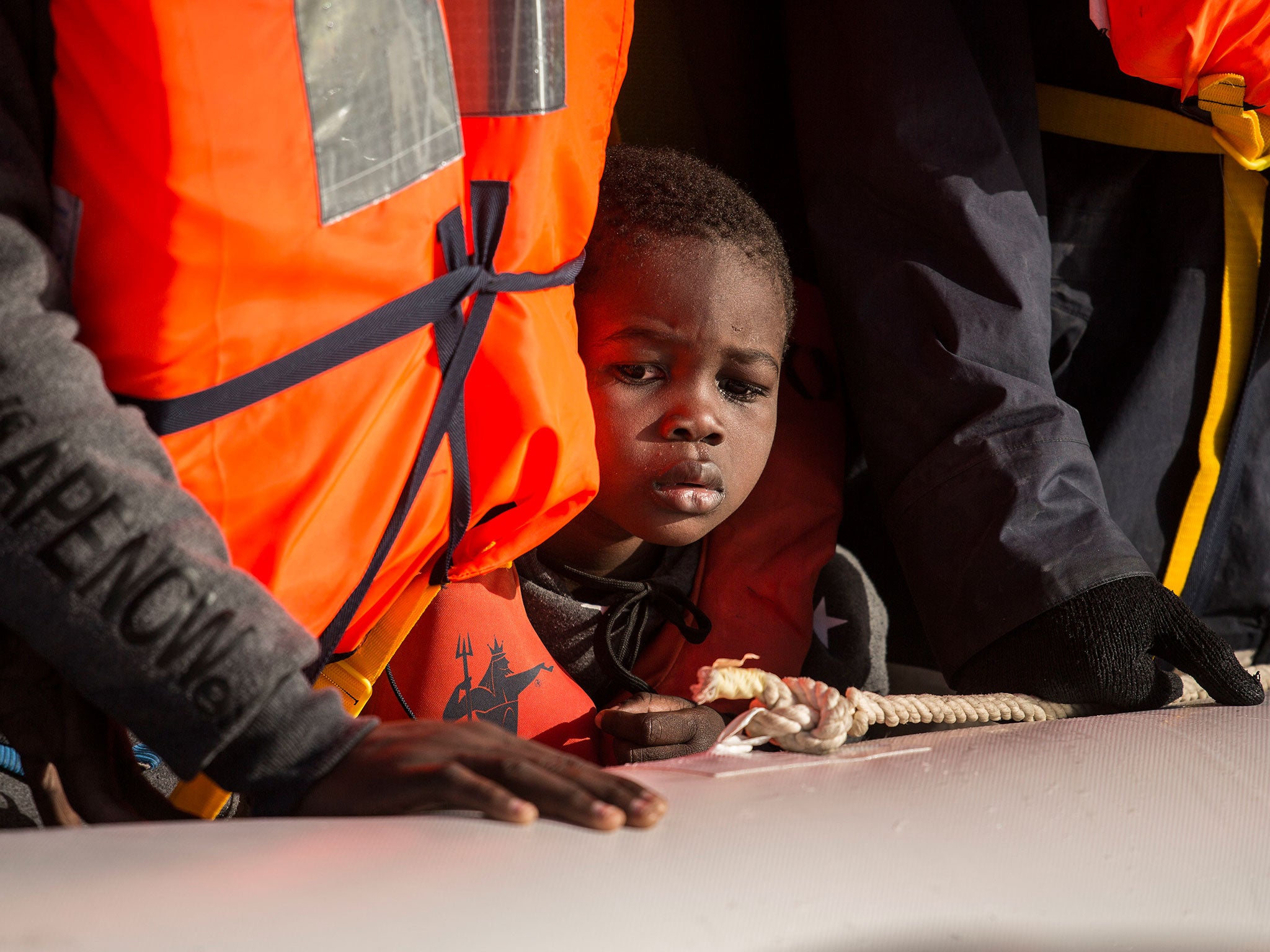 Migrants being rescued rescued by members of Proactiva Open Arms NGO in the Mediterranean Sea on 12 January