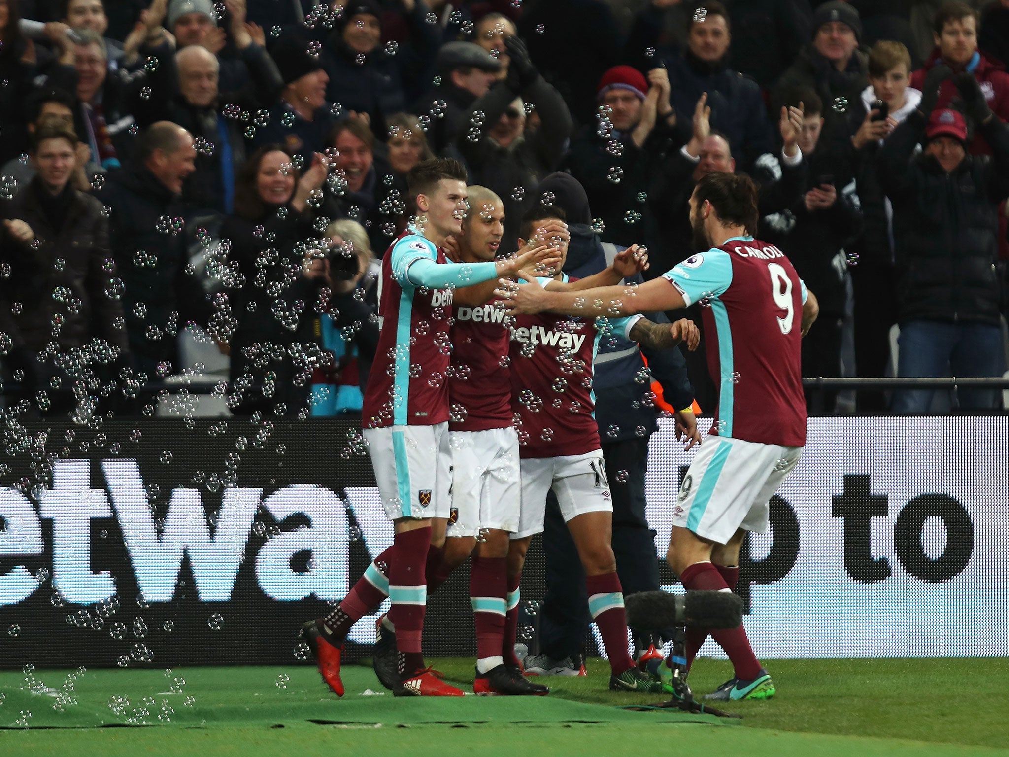 Feghouli celebrates with his team mates after scoring the side's second