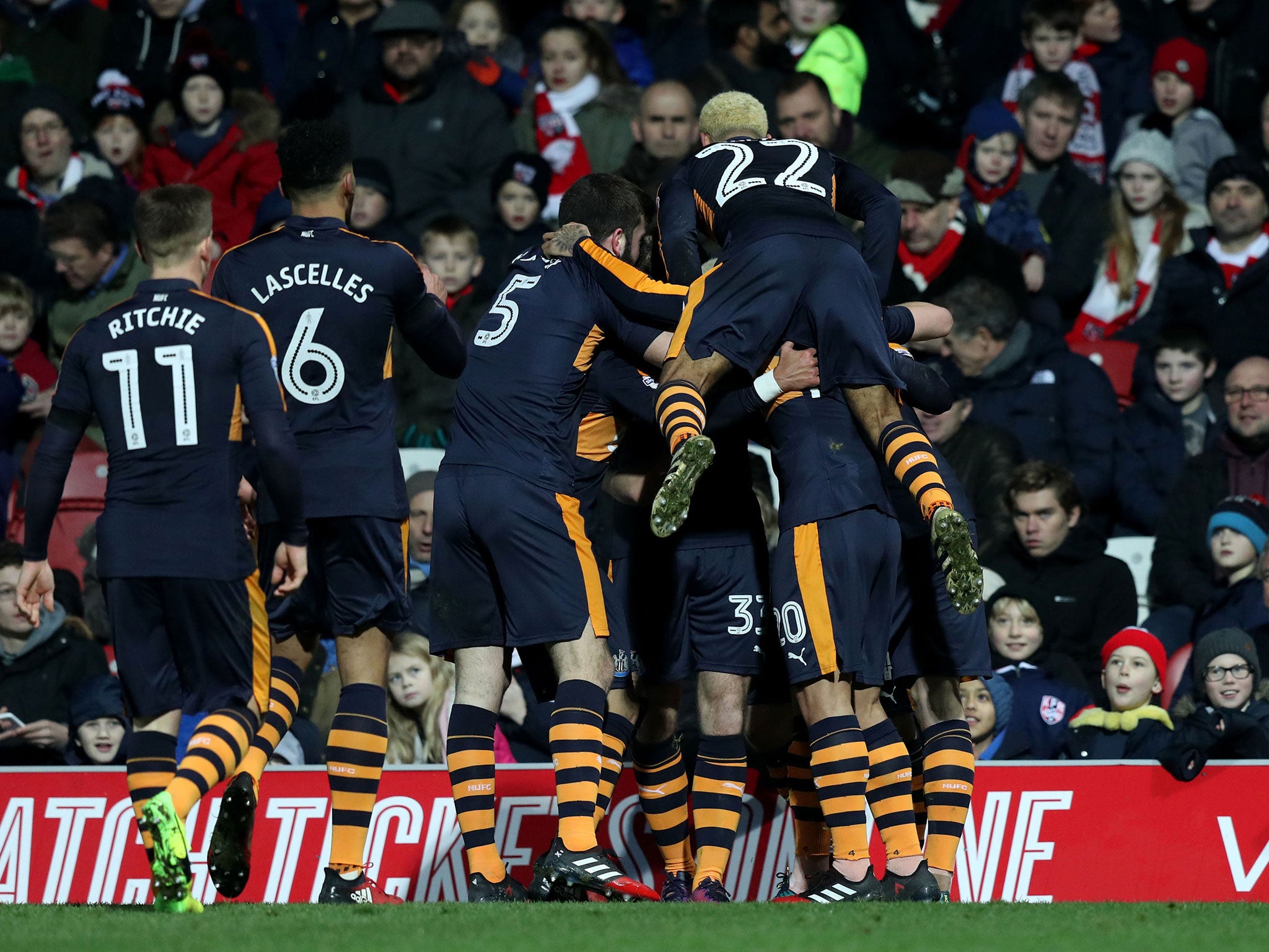 Newcastle players celebrate together after the side's second