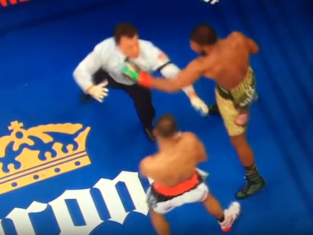 Referee Arthur Mercante Jr takes a left hook straight to the face