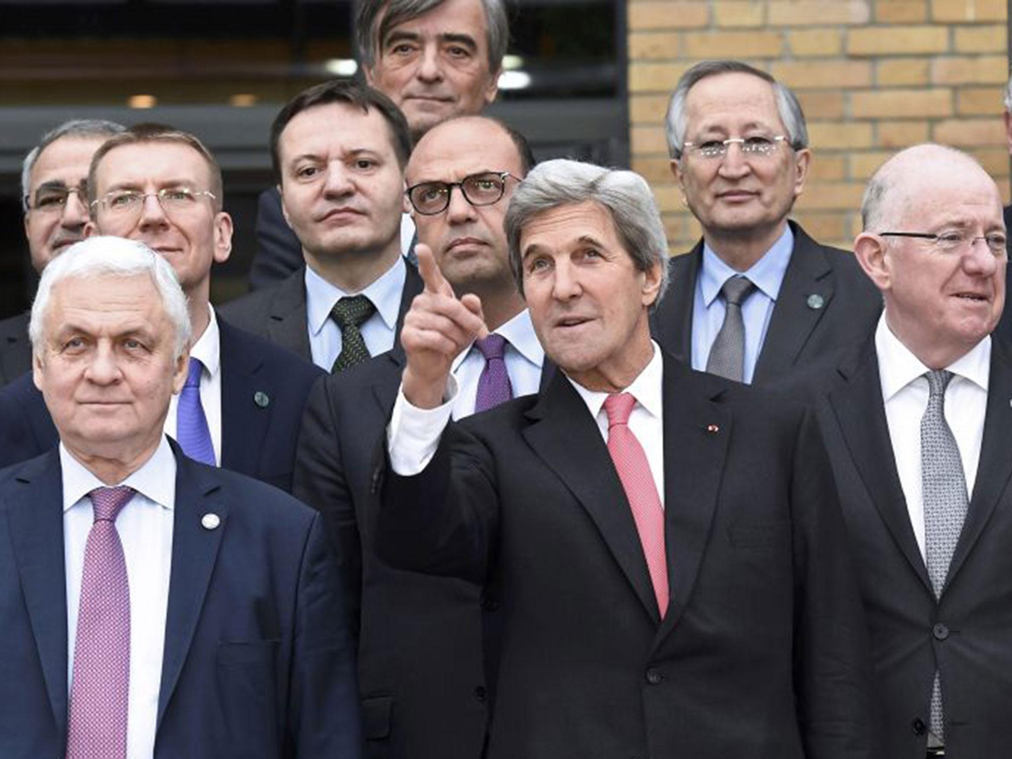 US Secretary of State John Kerry (C) gestures next to Russian Ambassador to France Alexander Orlov (L) with other foreign ministers and representatives peace conference in Paris