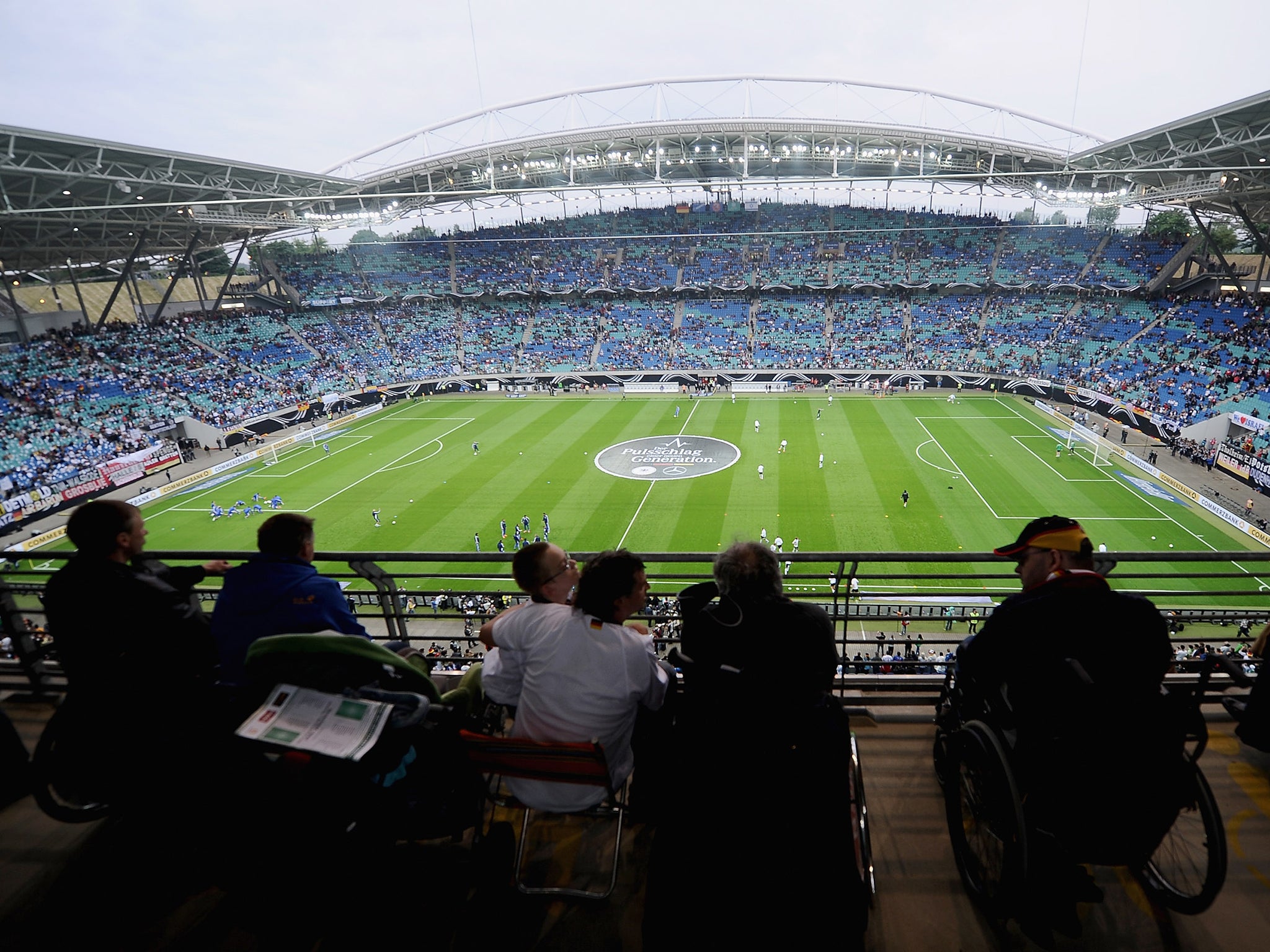 People in wheelchairs attend an international football match in Germany