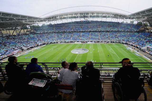 People in wheelchairs attend an international football match in Germany