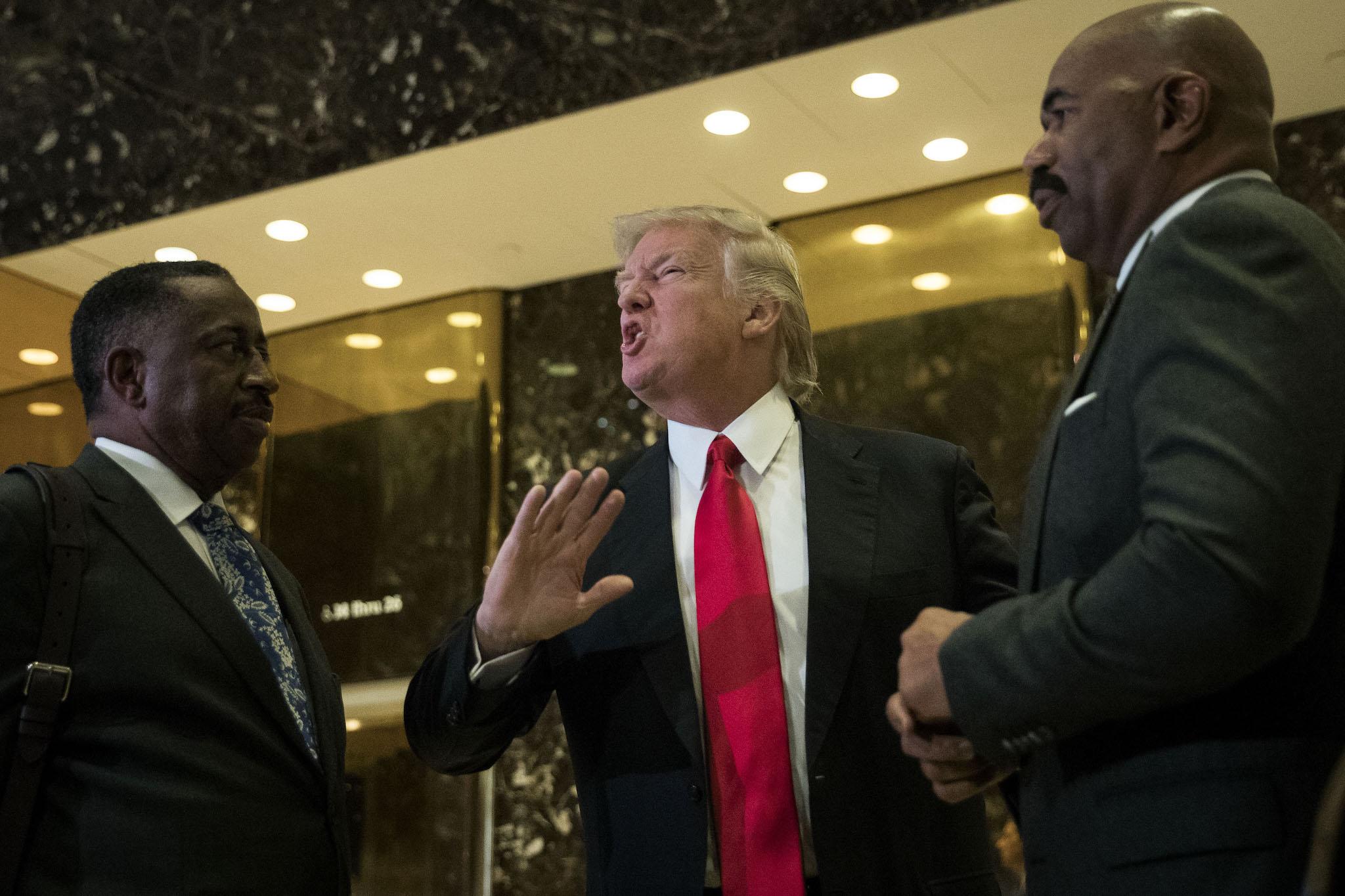 President-elect Donald Trump (C) and television personality Steve Harvey speak to reporters after their meeting at Trump Tower, January 13, 2017 in New York City. President-elect Trump continues to hold meetings at Trump Tower in New York