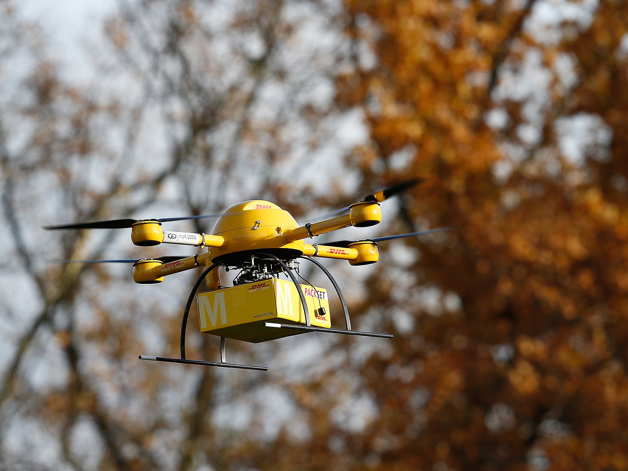 A quadcopter drone arrives with a small delivery at Deutsche Post headquarters