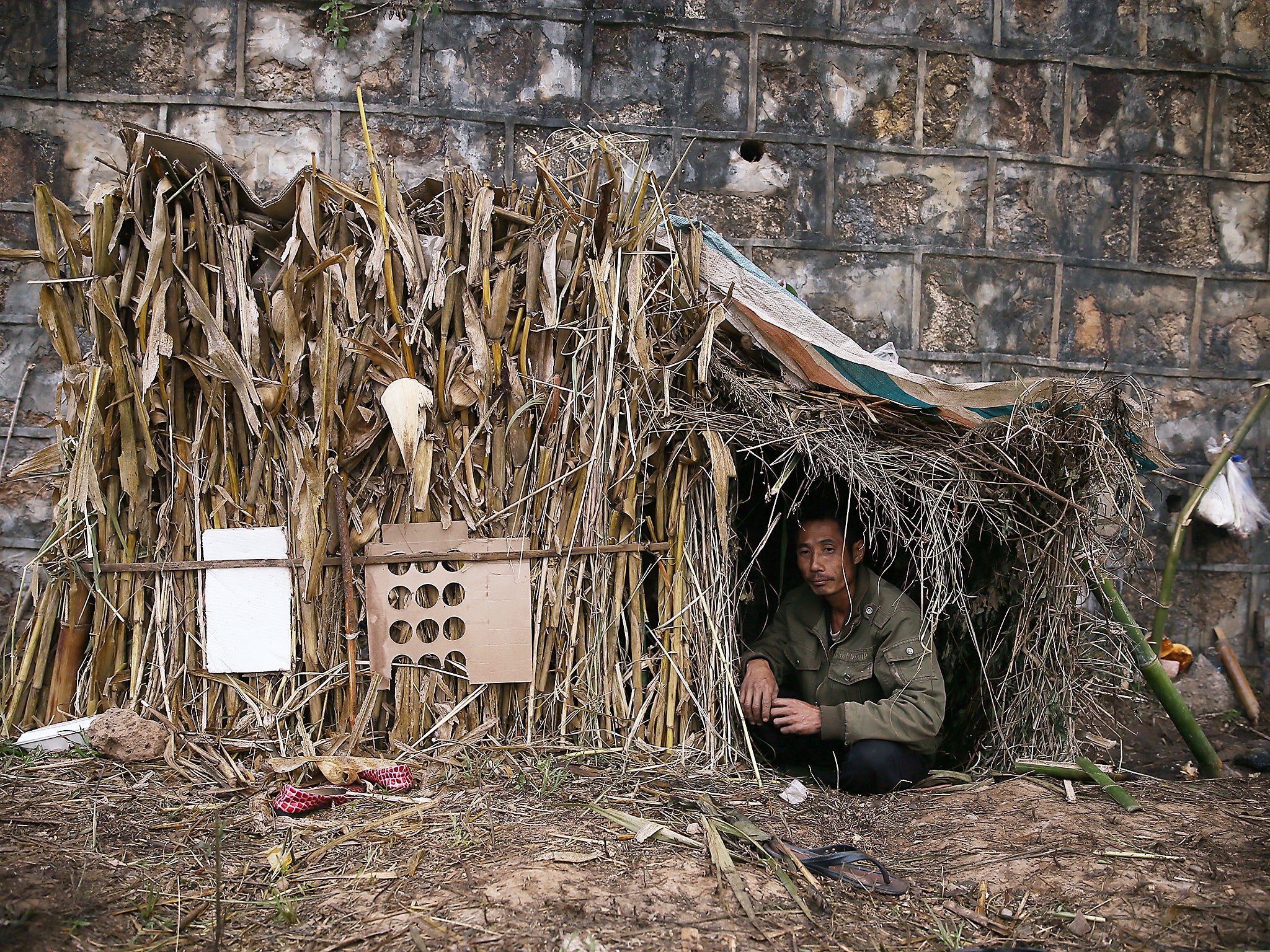 A refugee from Burma rests in a temporary shelter in Wanding, in China’s southwest Yunnan province (Getty)