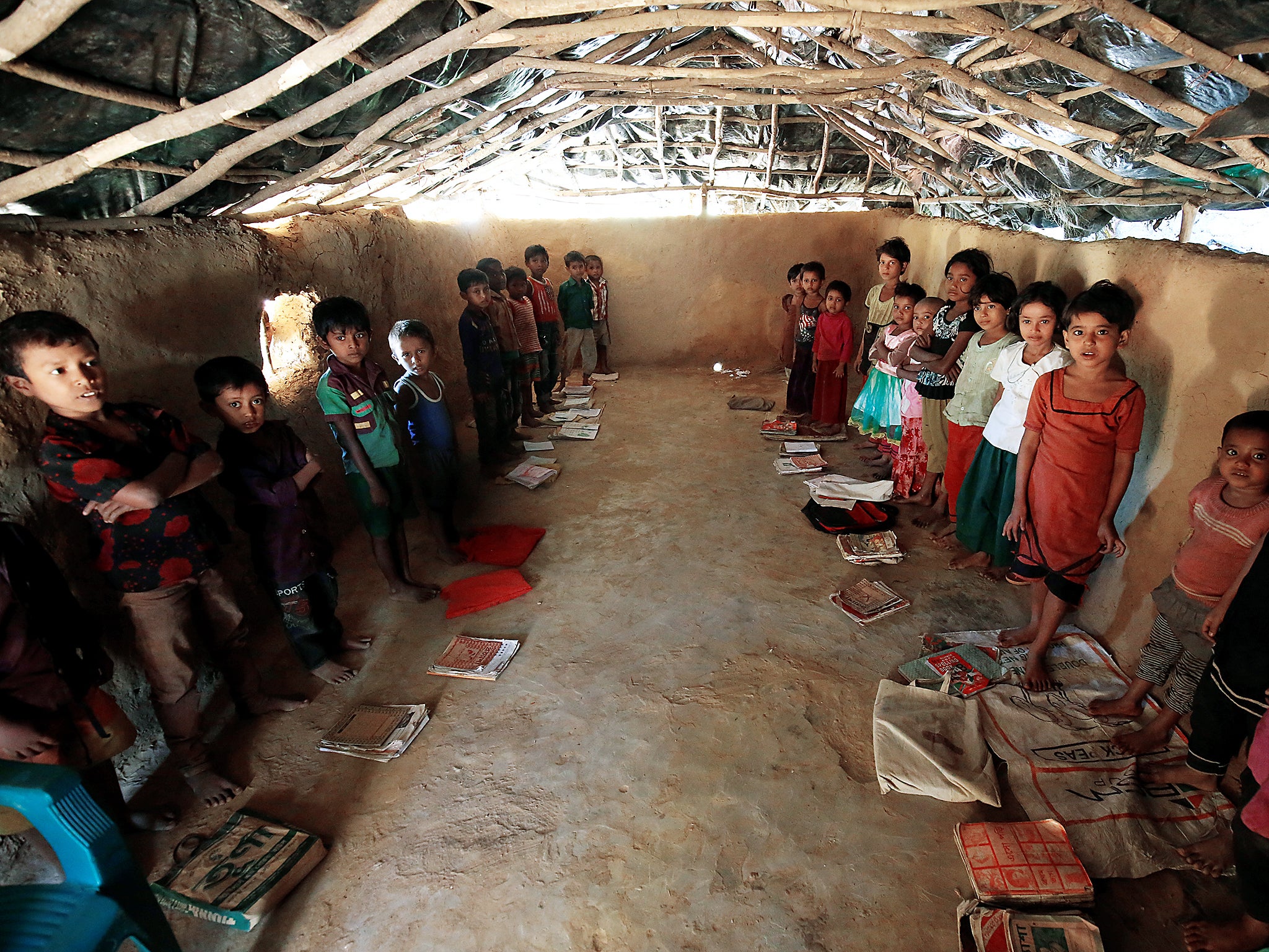 Rohingya children react to the camera as they attend a class at a school inside the Kutupalang Refugee Camp in Cox’s Bazar, Bangladesh