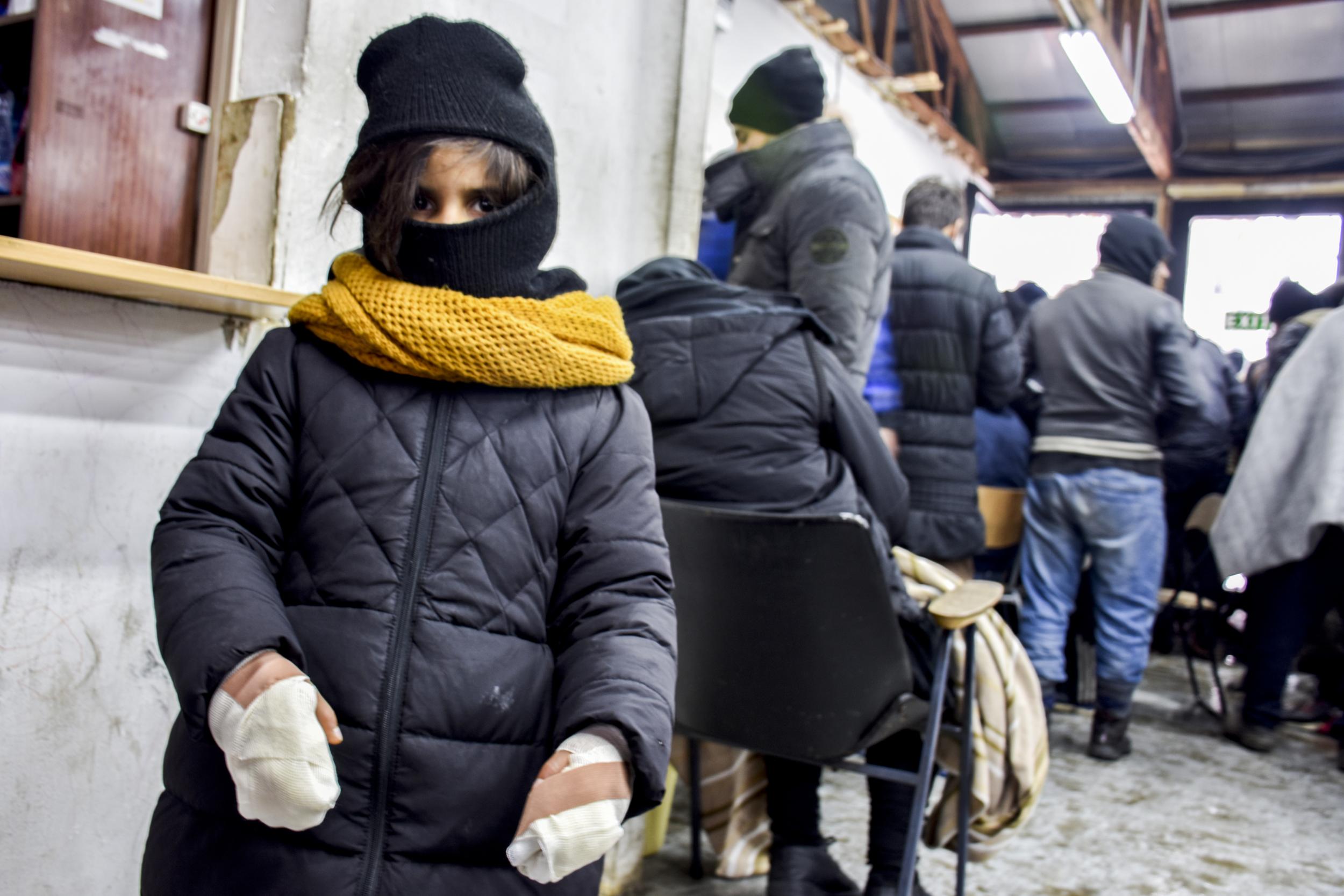 A young girl is pictured in freezing Belgrade after travelling for days with her family in temperatures as low as -10C
