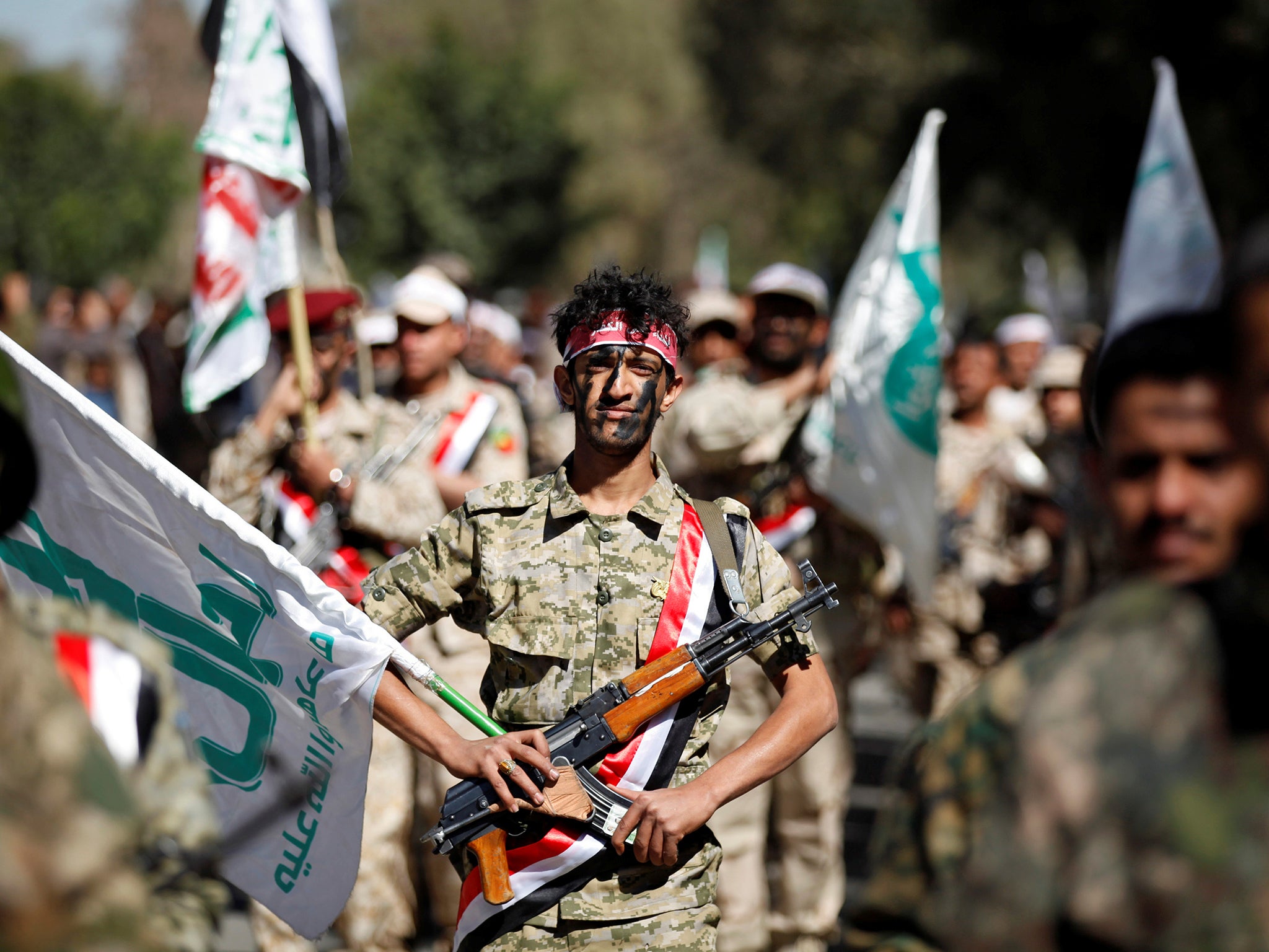 Newly recruited Houthi fighters parade before heading to the frontline to fight against government forces in Sanaa