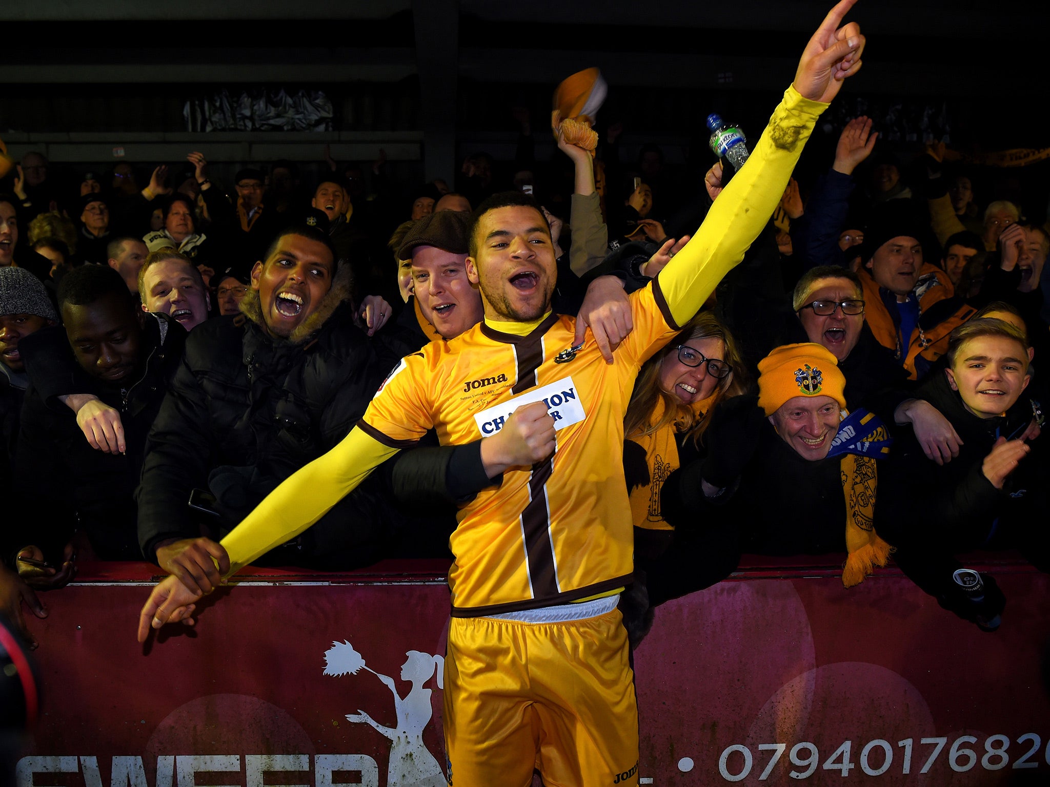 Maxime Biamou, scorer of Sutton's second goal, could not help but celebrate with the fans at the final whistle