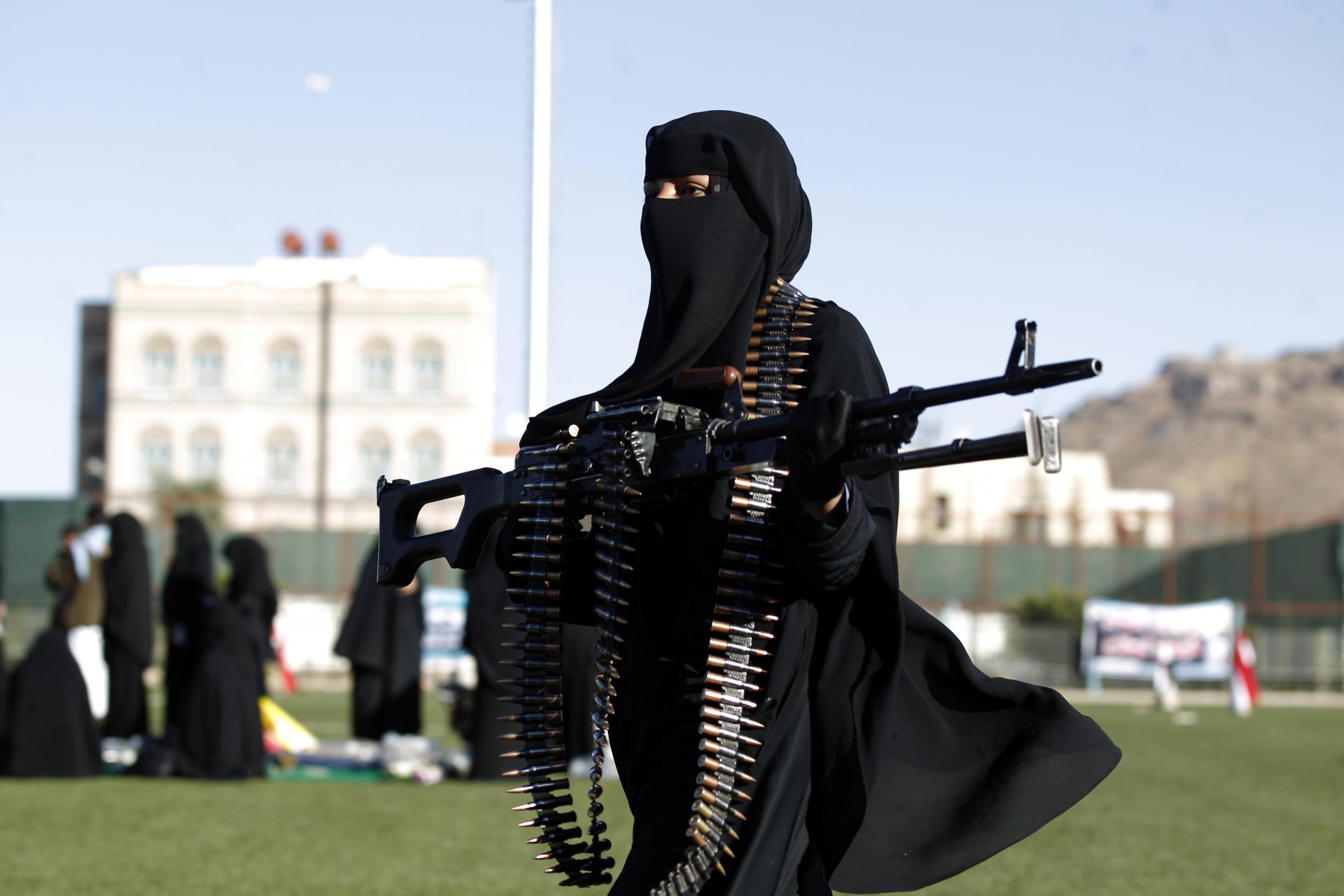 A lone fighter holds a ceremonial weapon at the pro-Huthi rally