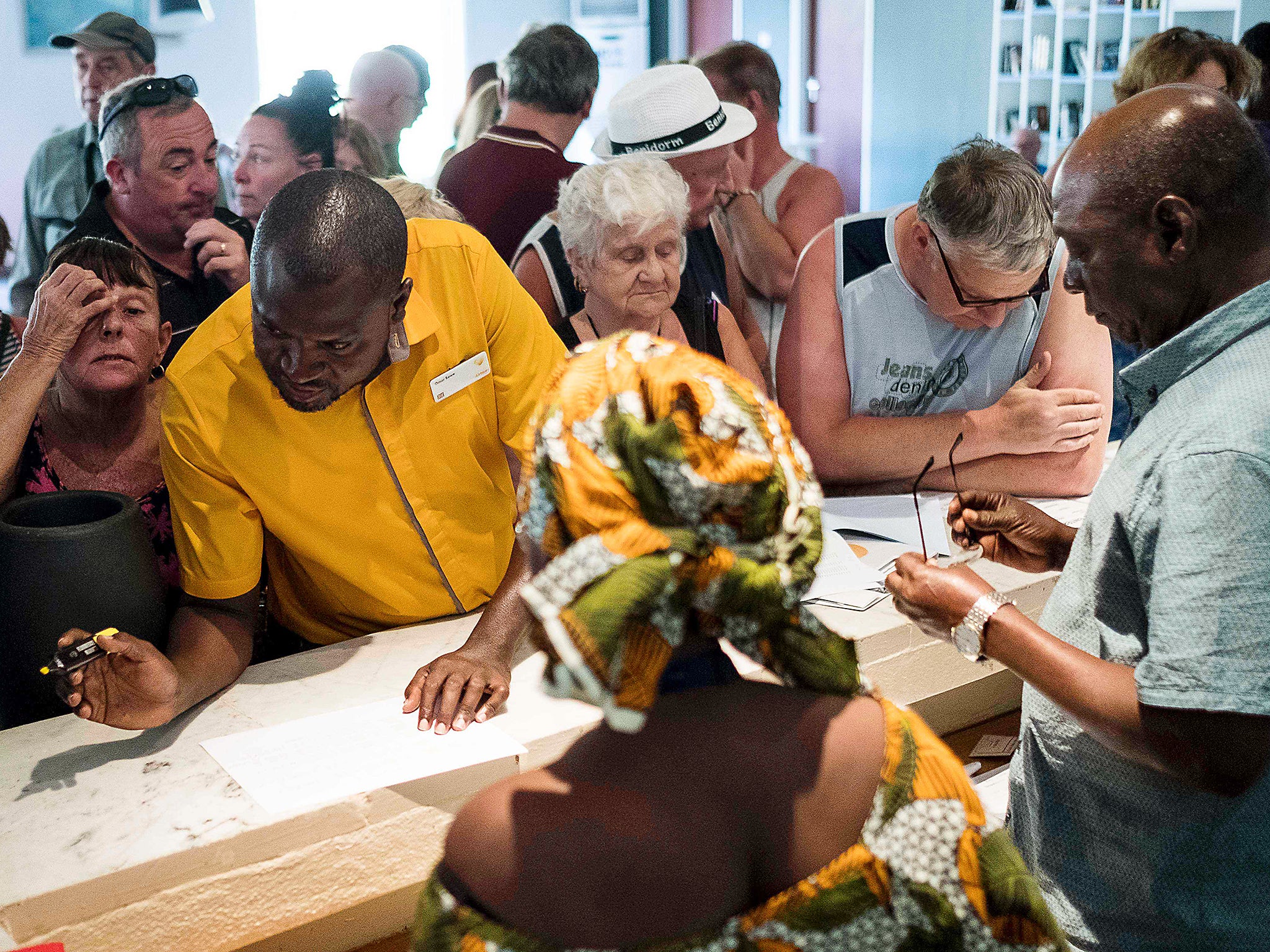 A Thomas Cook travel representative helps tourists prepare to leave the Gambia after the British Government changed the travel advisory to amber due to the state of emergency issued by President Jammeh in Banjul, Gambia