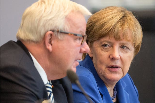 German Chancellor Angela Merkel talks to Michael Fuchs