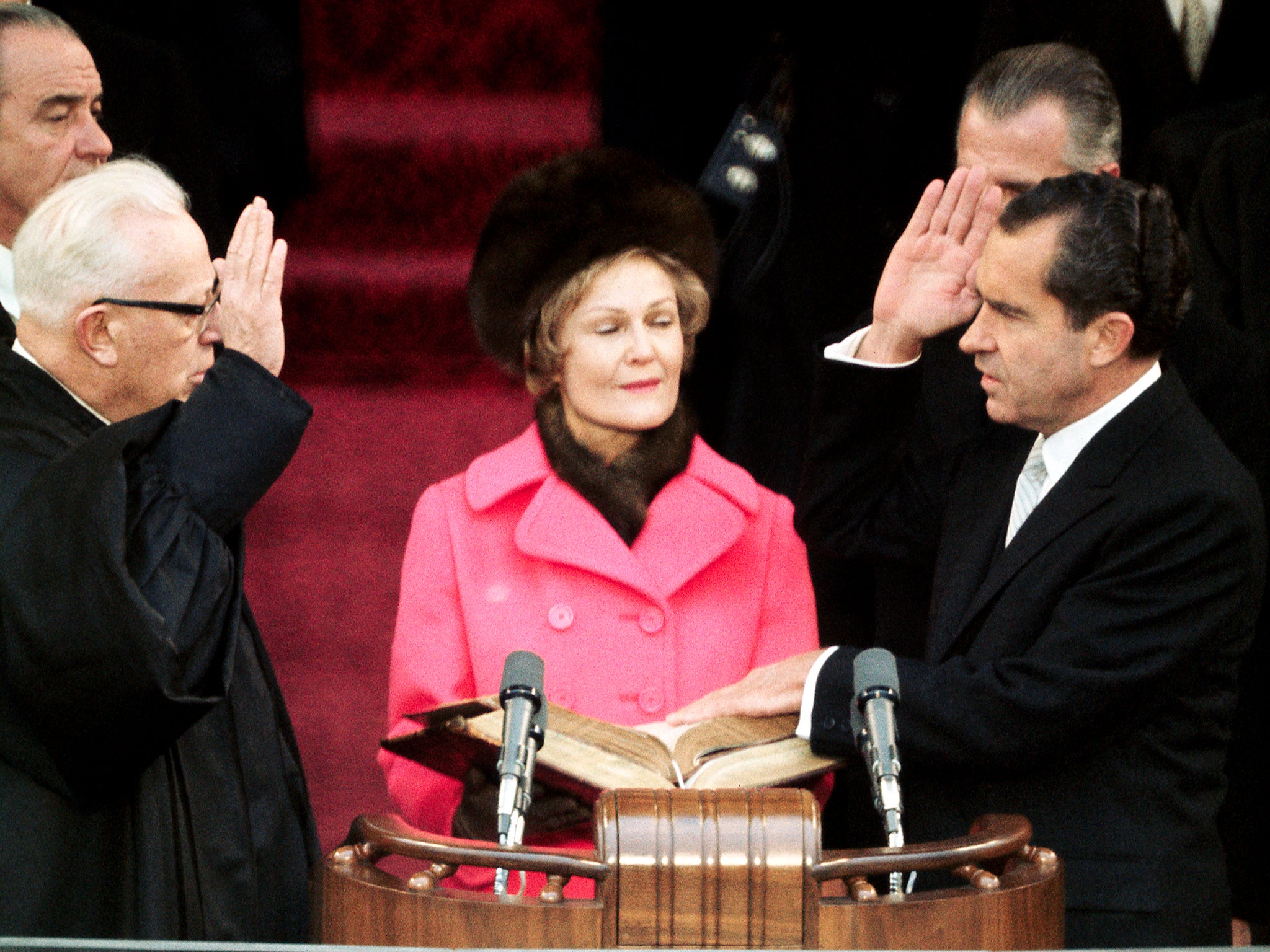 Chief Justice Earl Warren?swears in the 37th president on 20 January 1969, as Nixon’s wife Pat looks on