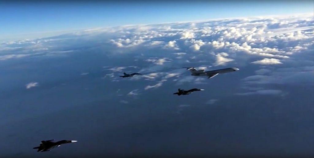 A Russian Foreign Ministry video grab made on March 15, 2016, shows Russian Su-34 bombers and a Tupolev Tu-154 transport plane (R) flying above an unknown location in Syria
