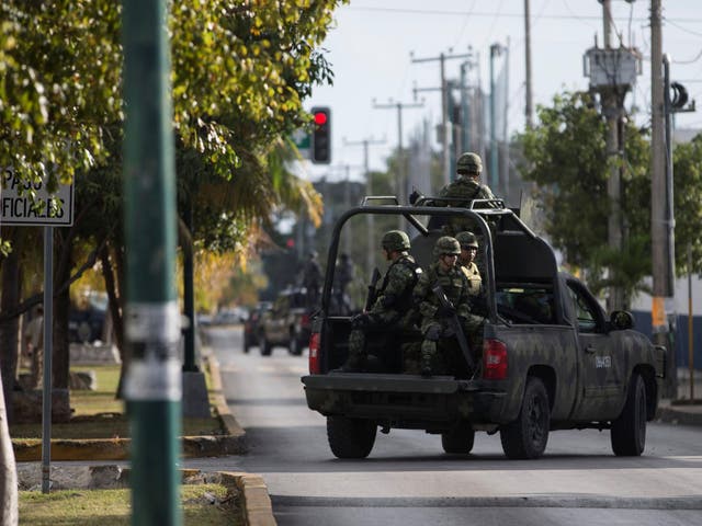 Soldiers are seen in a vehicle near the state attorney general's office after gunmen opened fire