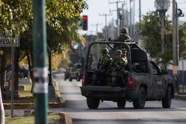 Soldiers are seen in a vehicle near the state attorney general's office after gunmen opened fire