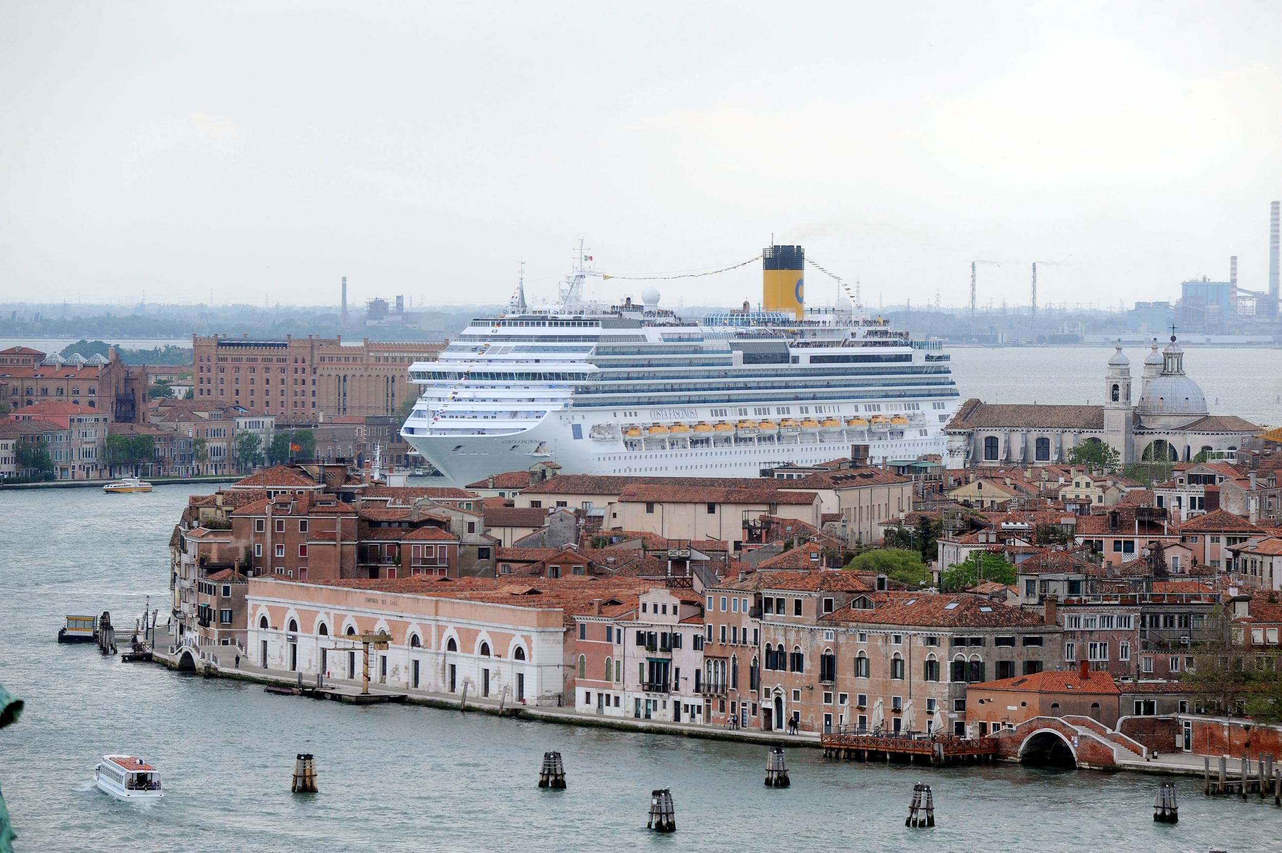 A cruise ship ploughs its way into Venice