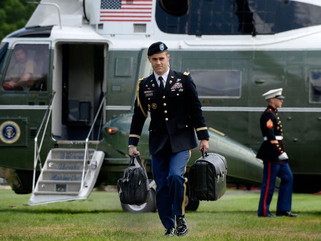 'The nuclear football', pictured being carried by an aide walking to the White House in May 2016, never leaves the president's side