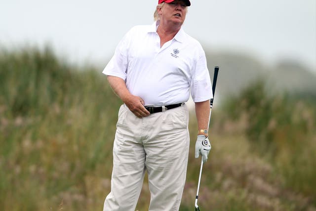 Donald Trump plays a round of golf after the opening of his Scottish course