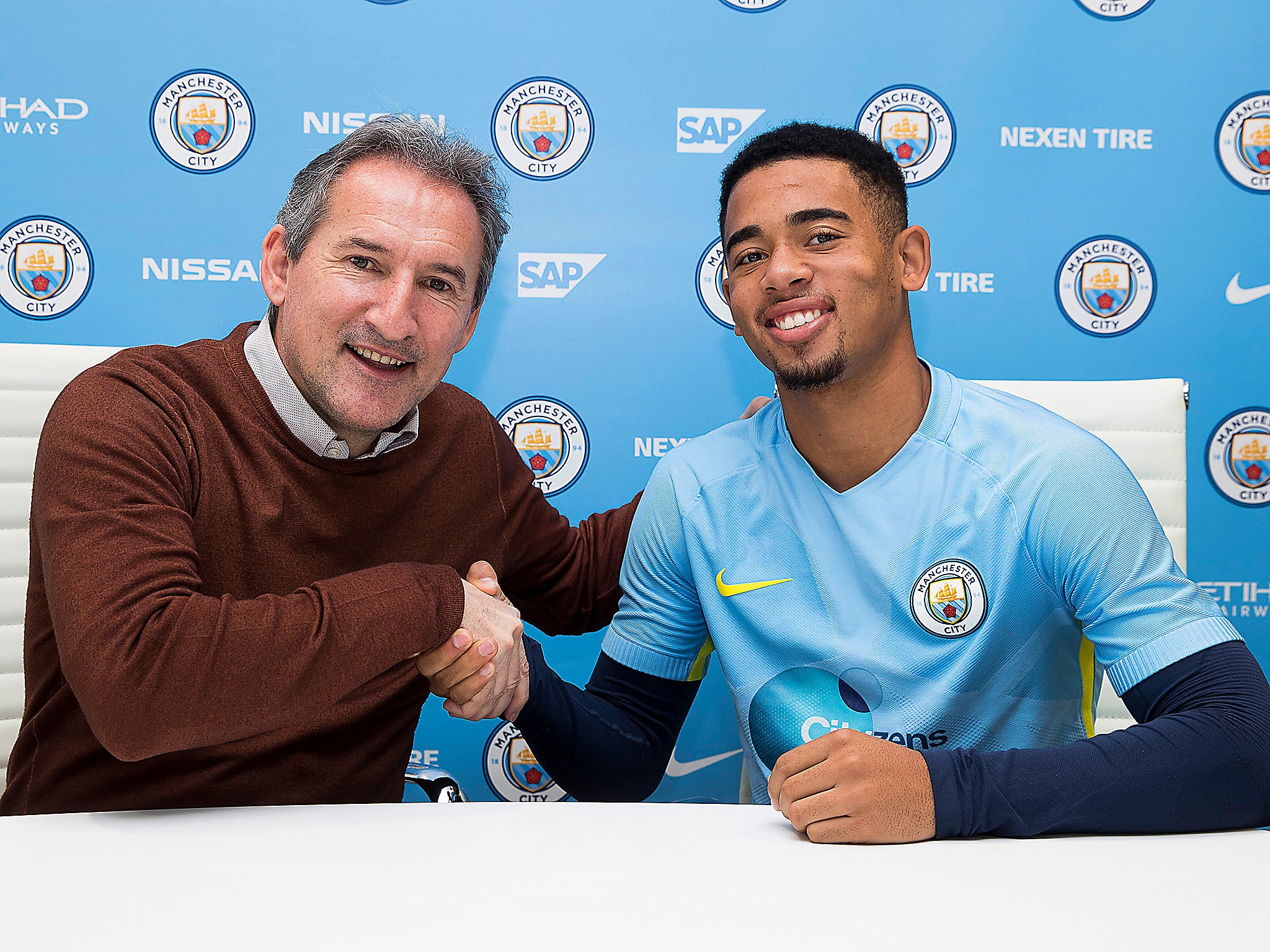 Manchester City chief Txiki Begiristain shakes hands with new signing Gabriel Jesus