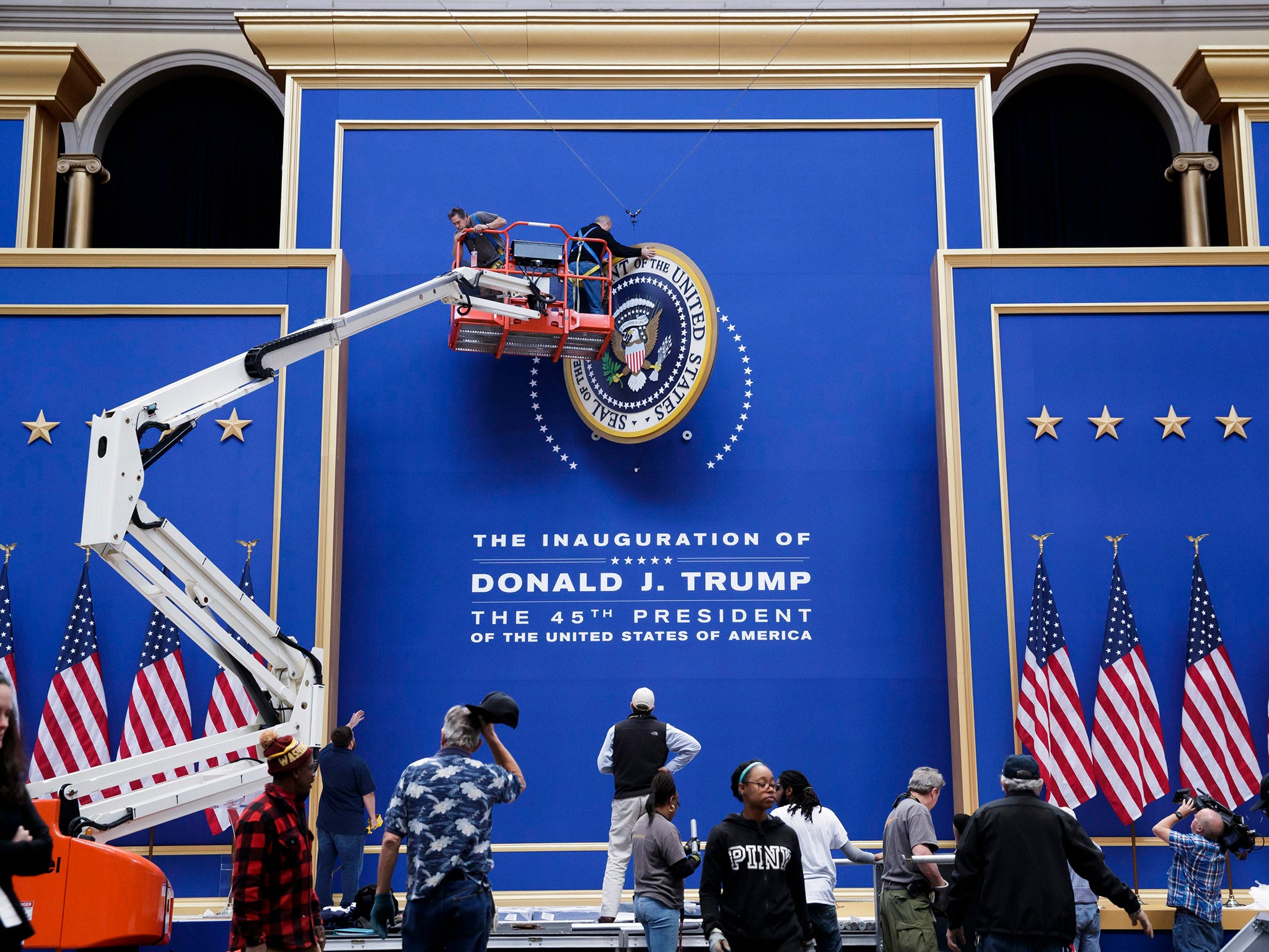 Workers assemble the stage for the Commander-in-Chief Ball at the National Building Museum