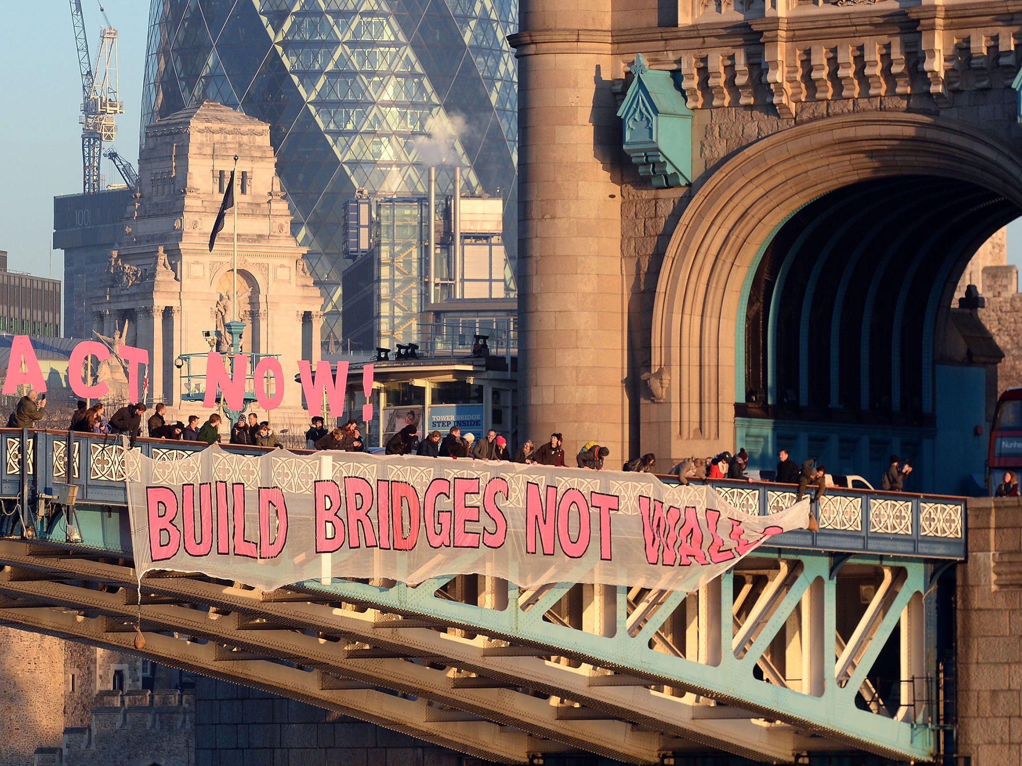 A banner unfurled on Tower Bridge in London as part of the Bridges Not Walls protest against US President Donald Trump on the day of his inauguration.