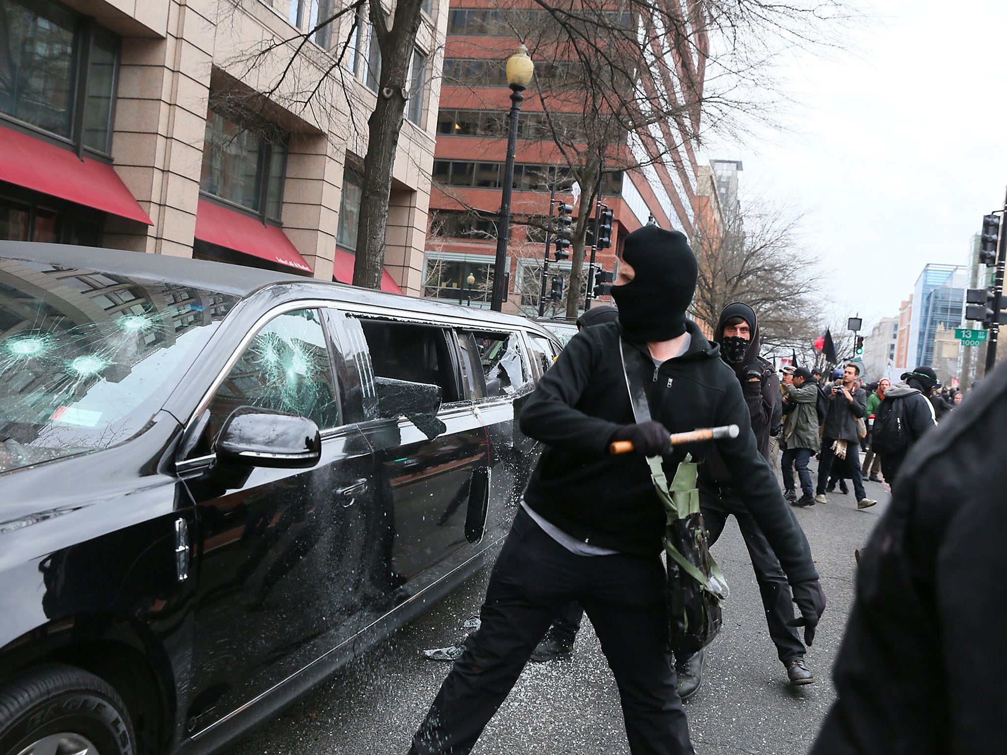 Anti-facist protestors smash the windows of a Limousine in Washington DC