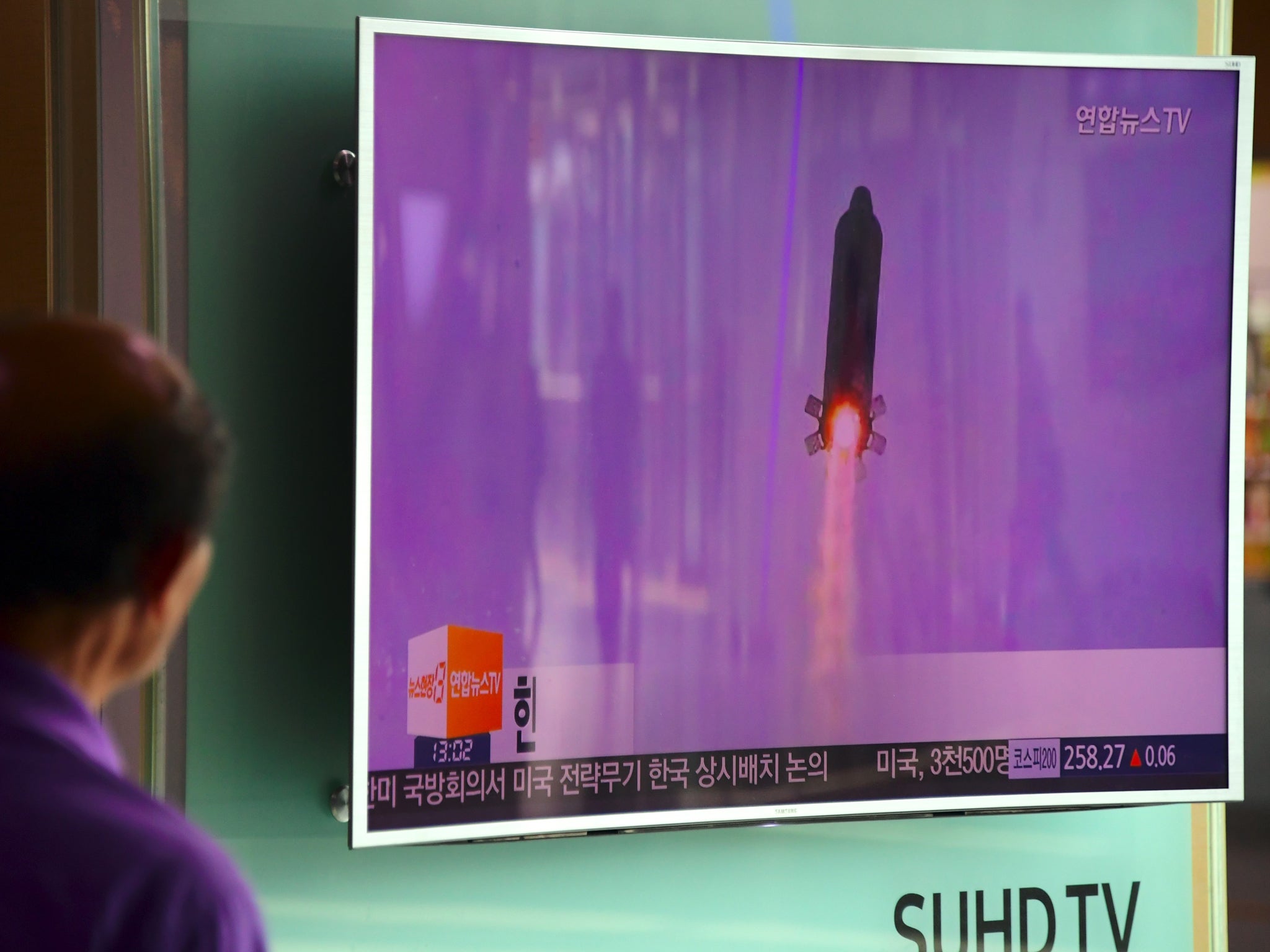 A man in Seoul watches file footage of a North Korea missile launch