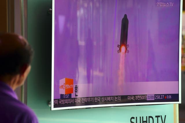 A man in Seoul watches file footage of a North Korea missile launch