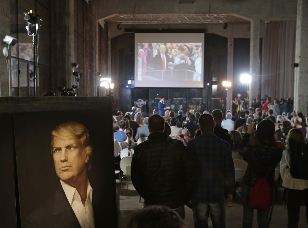 People watch the presidential inauguration ceremony for Donald Trump in a network and party location in Moscow