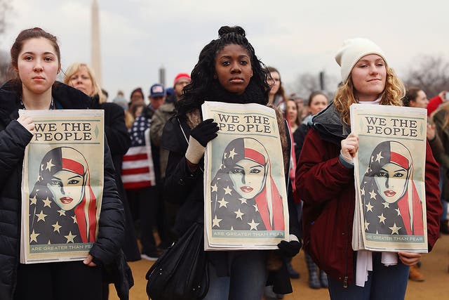 Protesters on the national mall watch the inauguration of US President Donald Trump