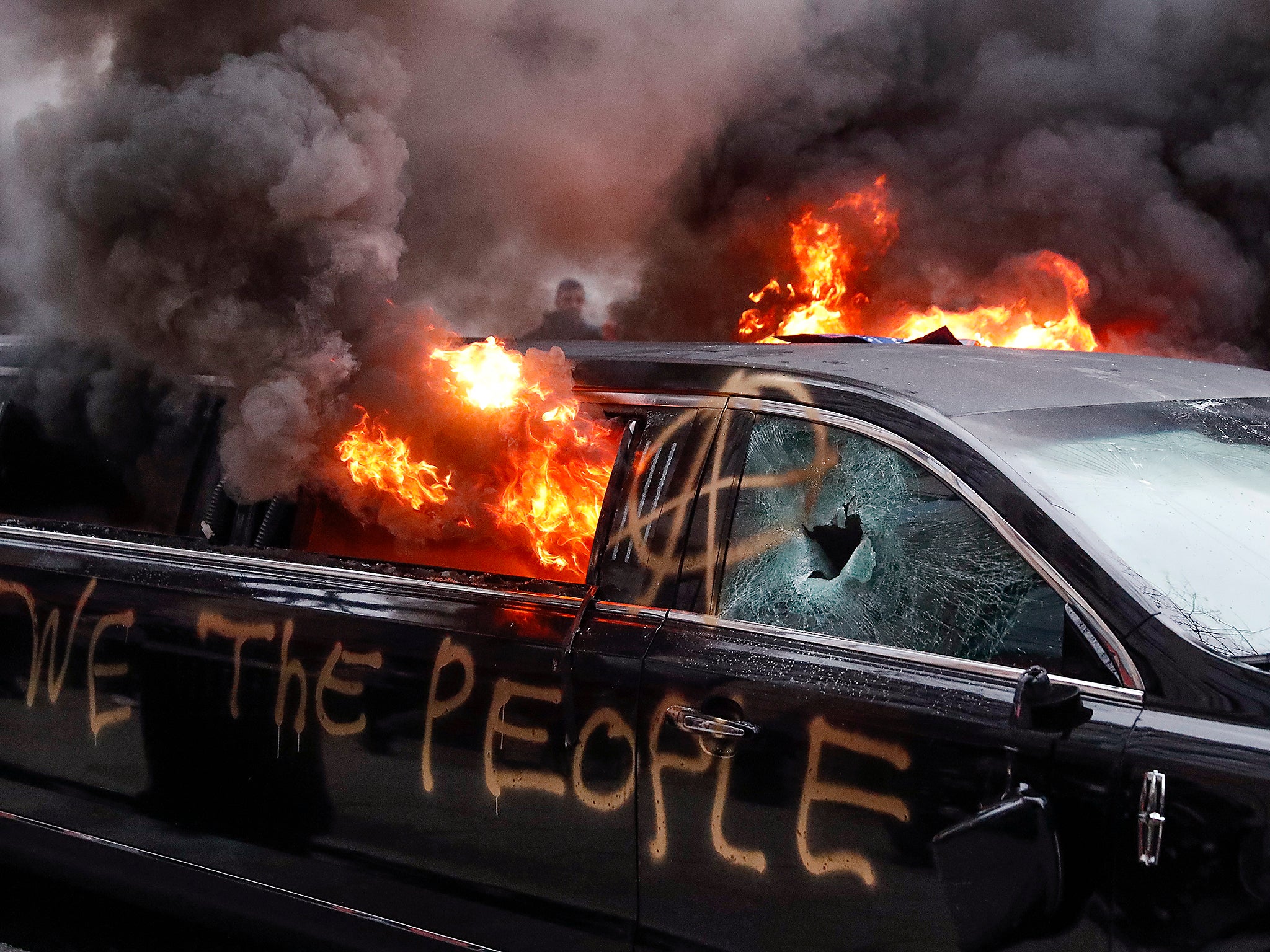 Protesters registered their rage against the new president Friday in a chaotic confrontation with police who used pepper spray and stun grenades in a melee just blocks from Donald Trump's inaugural parade route. Scores were arrested for trashing property and attacking officers