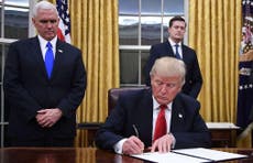 Trump signs his first executive order to “ease burden of Obamacare"