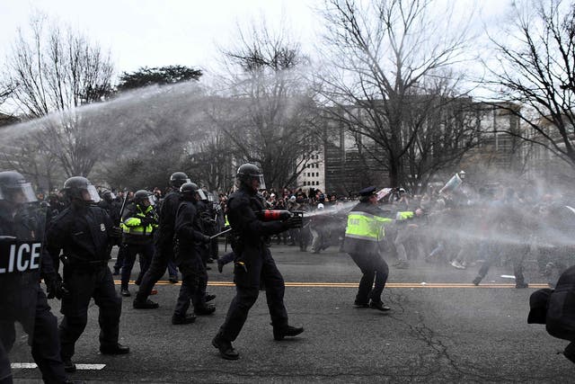 Police pepper spray anti-Trump protesters during clashes with police in Washington, DC, on January 20, 2107