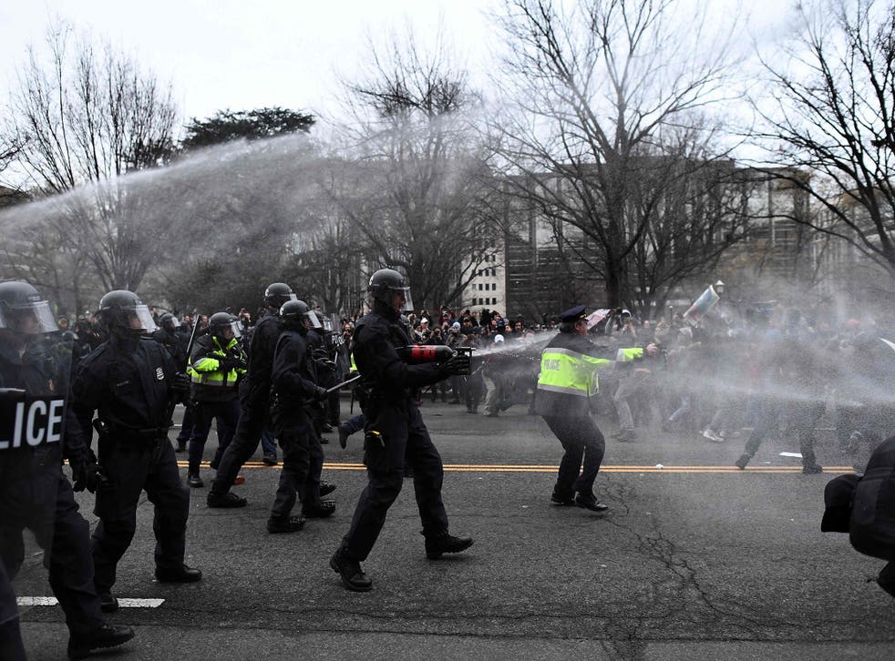 Police pepper spray anti-Trump protesters during clashes with police in Washington, DC, on January 20, 2107