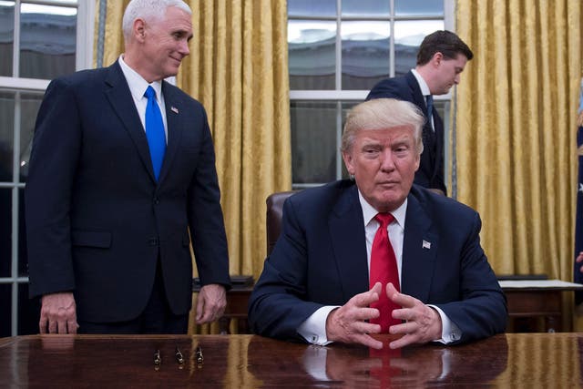 President Donald Trump sits in the Oval Office, before signing approvals for the appointment of Generals Mattis and Kelly to his first Cabinet