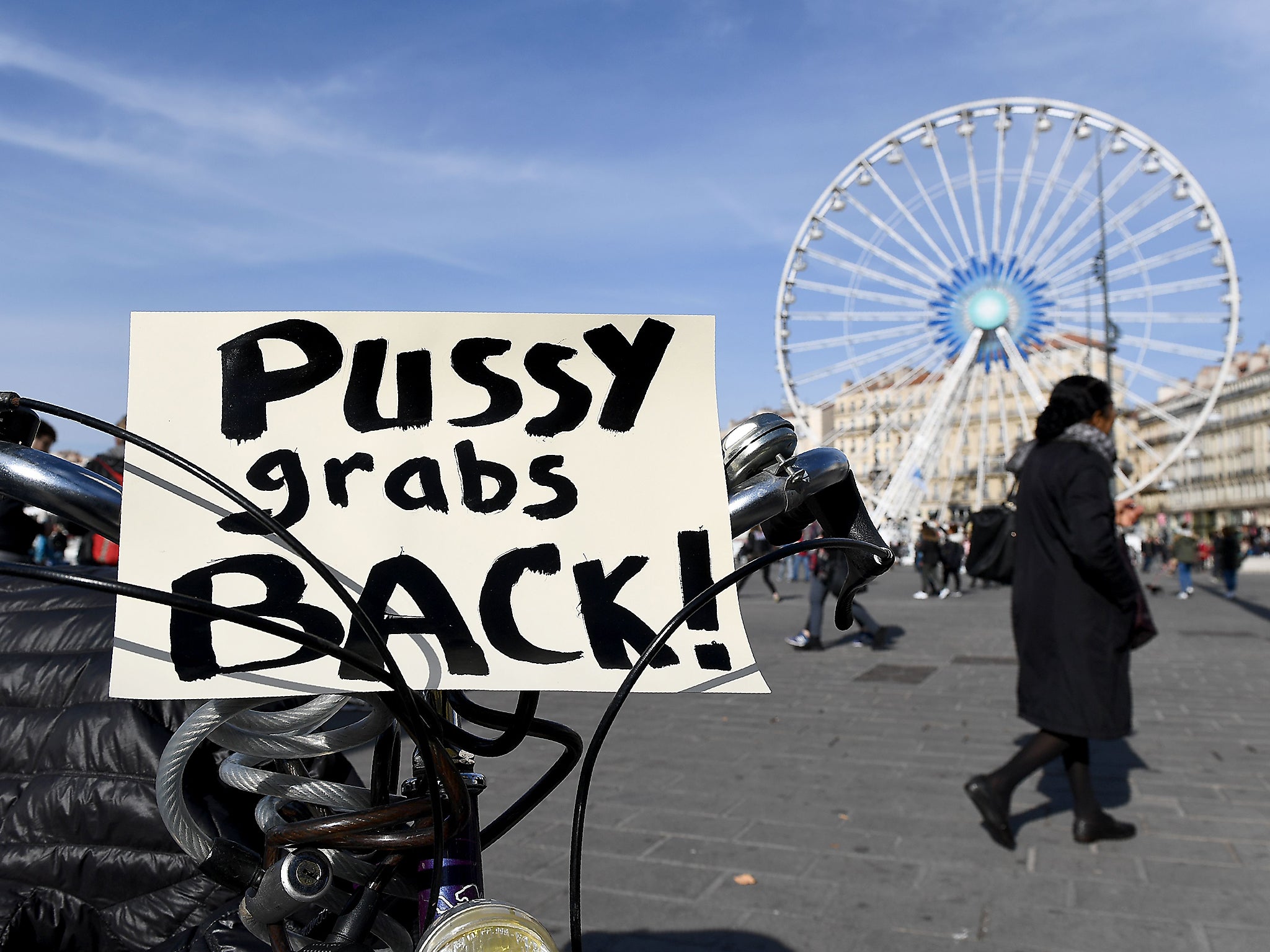 A placard reads 'Pussy grabs back' during a 'Womens' March' in Marseille against Donald Trump
