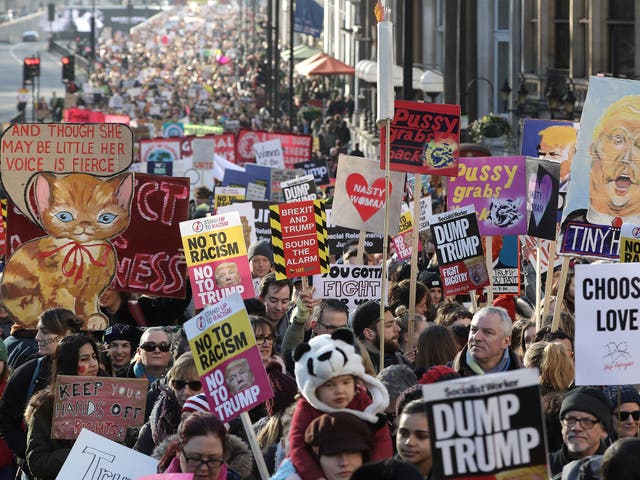 Protesters make their way through the streets of London during the Women's March on January 21, 2017 i