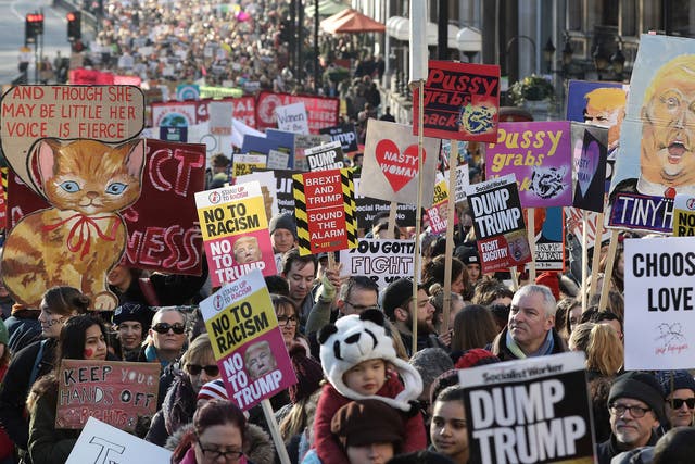 Protesters make their way through the streets of London during the Women's March on January 21, 2017 i