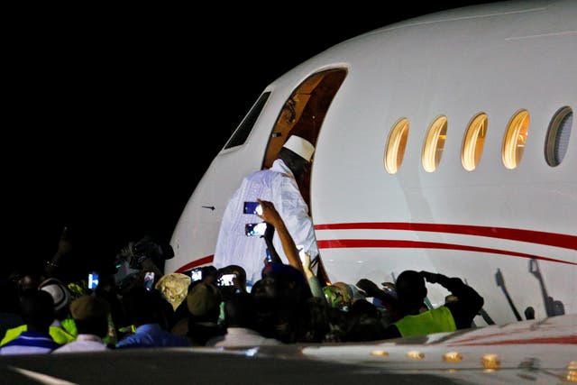 Former Gambian president Yahya Jammeh boards a private jet before departing Banjul airport