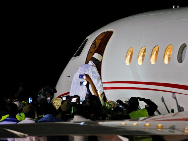Former Gambian president Yahya Jammeh boards a private jet before departing Banjul airport