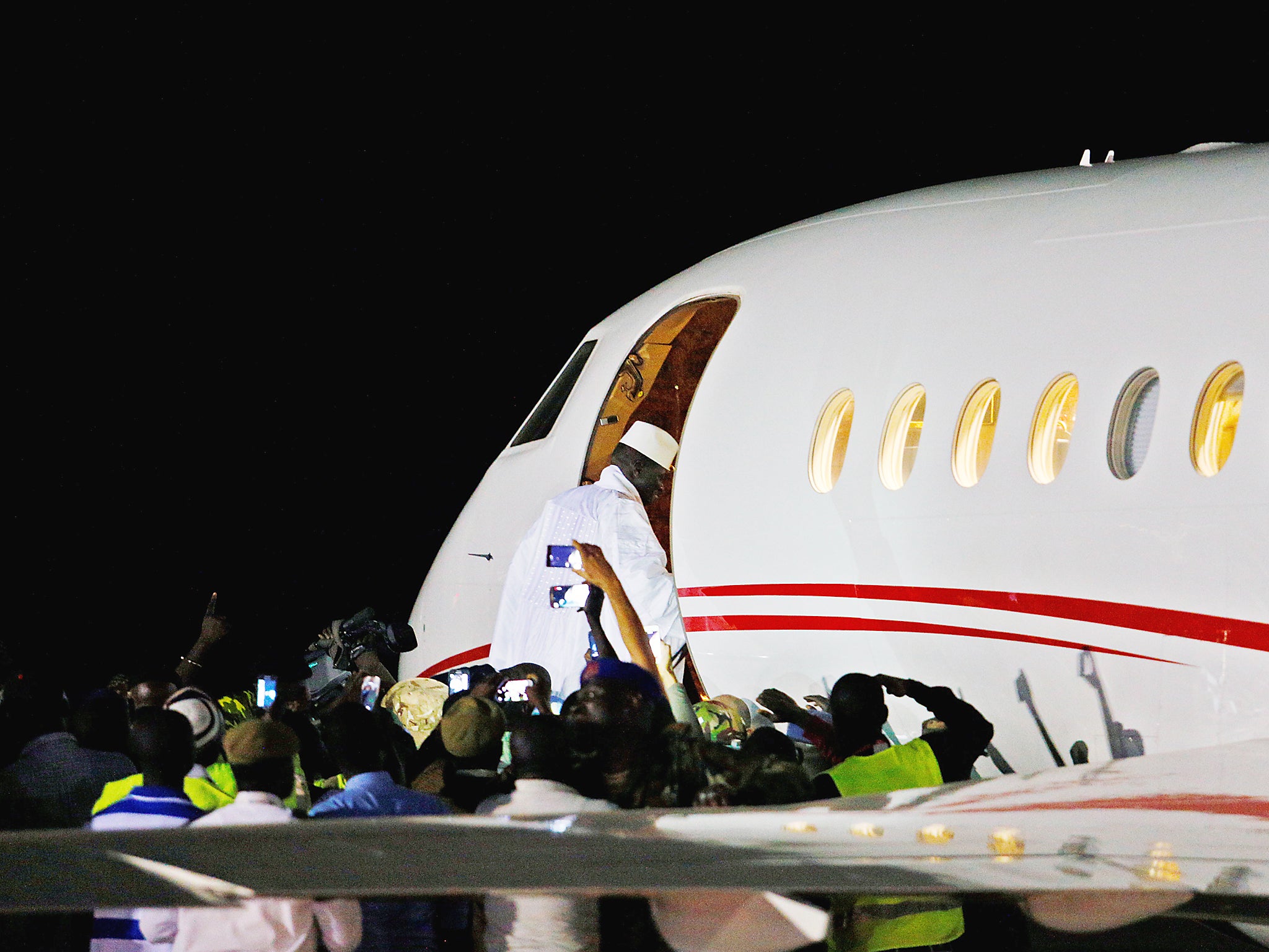 Former Gambian president Yahya Jammeh boards a private jet before departing Banjul airport, Gambia