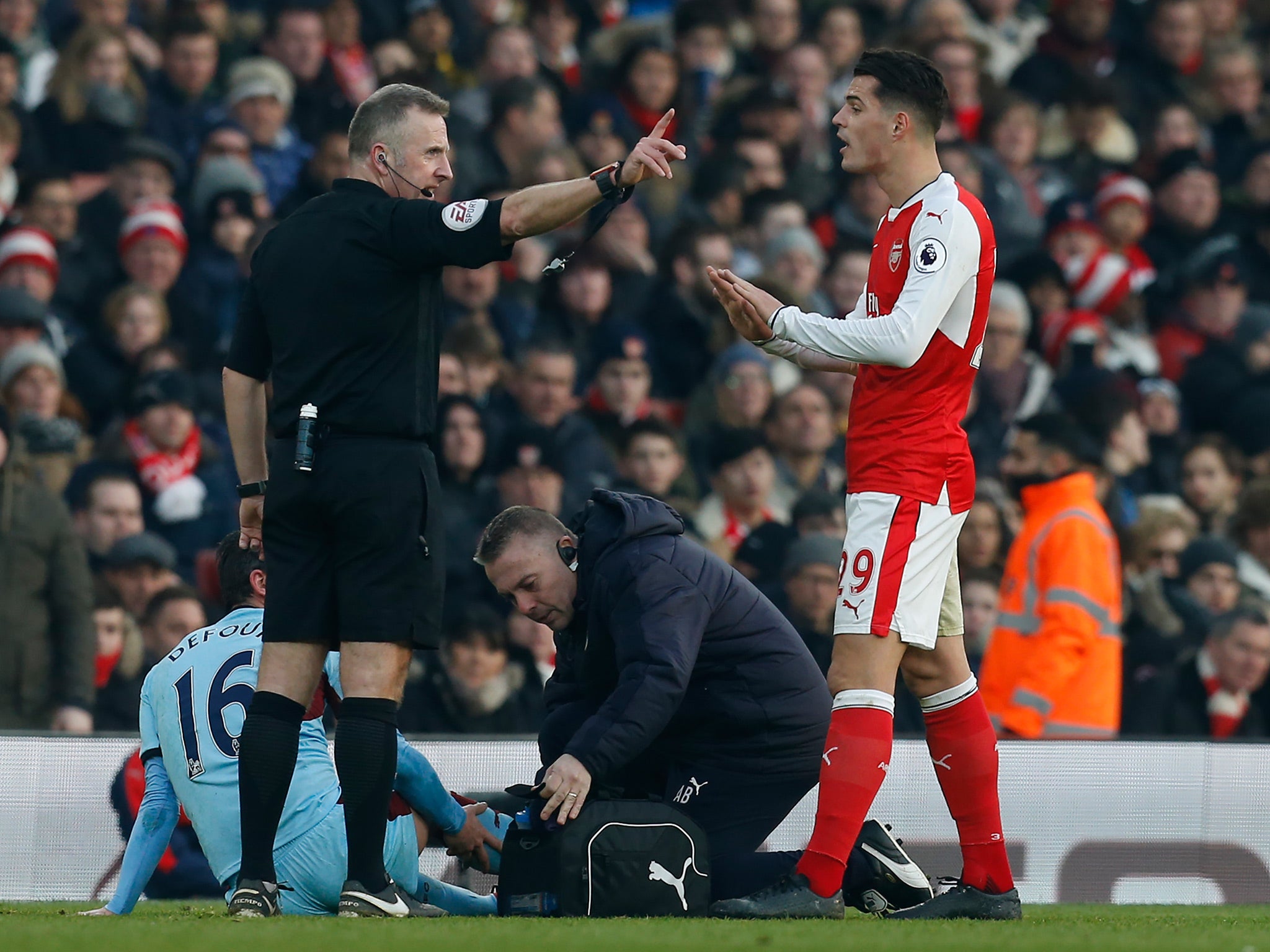 Jonathan Moss sent Granit Xhaka off for the second time this season after his tackle on Steven Defour