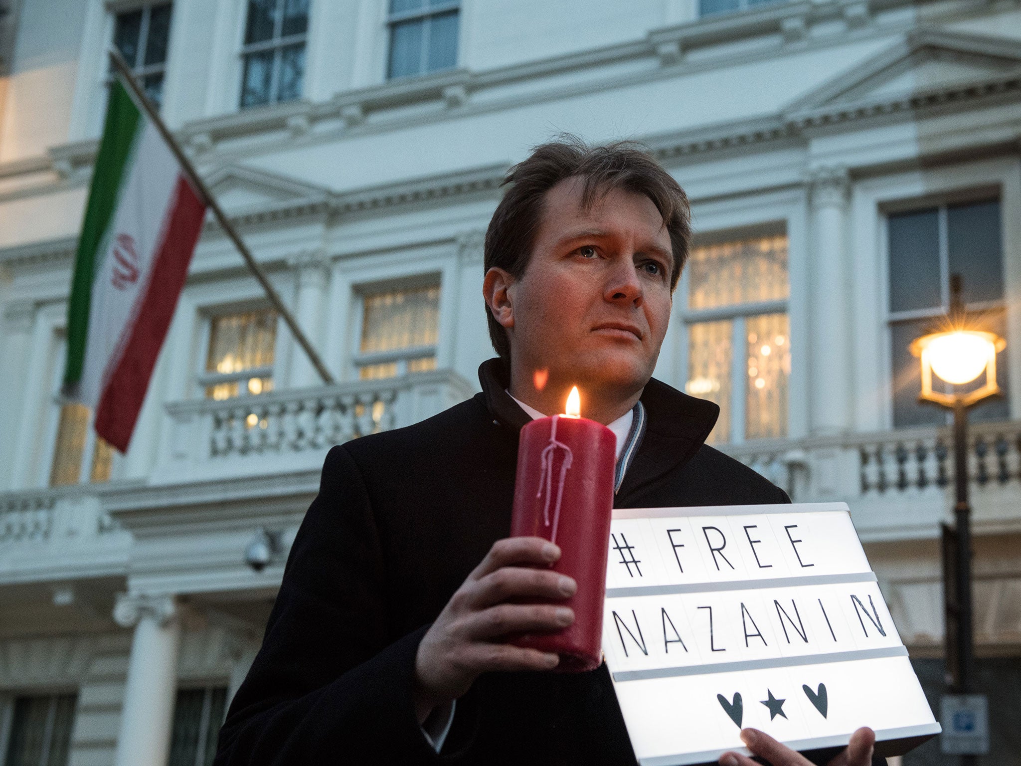 Richard Ratcliffe, husband of Nazanin Zaghari-Ratcliffe holds a '#Free Nazanin' sign and candle during a vigil for the British-Iranian mother