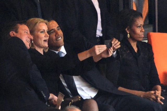 Obama and Cameron pose for a selfie taken by Denmark’s then prime minister, Helle Thorning-Schmidt, during the memorial service of Nelson Mandela on 10 December 2013